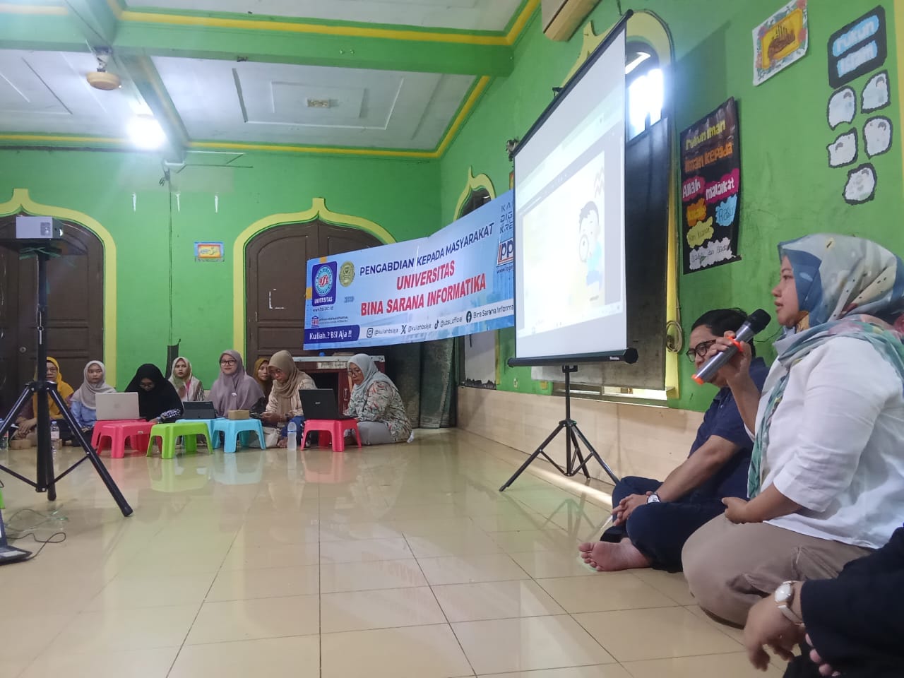 SAMBUTAN CERIA: Ibu Dharya Ghita S.Pd selaku Kepala PAUD Anyelir Kramat Jati, Jakarta Timur sedang menyampaikan kata sambutan ceria pada acara pengabdian kepada masyarakat (PKM) Dosen dan Mahasiswa UBSI dalam bentuk training untuk guru-guru PAUD Anyelir di Kramat Jati, Jakarta Timur, Minggu (26/10/2025).